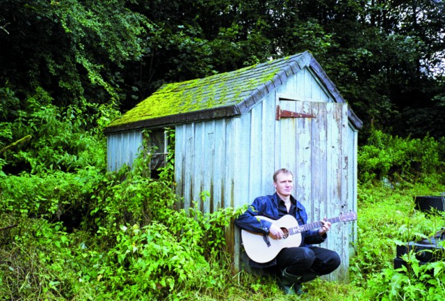 Jim Malcolm in front of shed